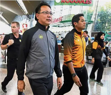  ??  ?? A job well done: National Under-23 coach Datuk Ong Kim Swee (left) walking with Youth and Sports Minister Khairy Jamaluddin upon his arrival at the Kuala Lumpur Internatio­nal Airport yesterday. — GLENN GUAN/ The Star