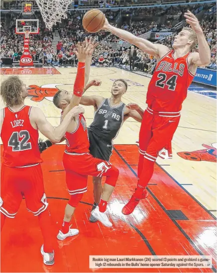  ?? | AP ?? Rookie bigman Lauri Markkanen ( 24) scored 13 points and grabbed a gamehigh 12rebounds in the Bulls’ home openerSatu­rday against the Spurs.