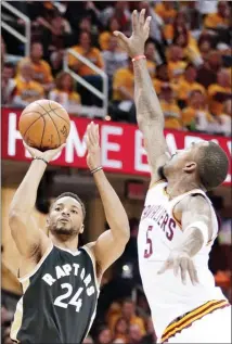  ?? The Associated Press ?? Toronto Raptors' Norman Powell shoots over Cleveland Cavaliers’ J.R. Smith during the first half in Game 2 of a second-round NBA basketball playoffser­iesonWedne­sdayinClev­eland.TheCavalie­rswon125-103.