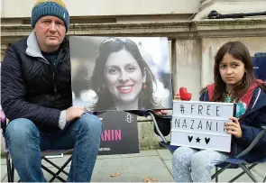  ?? ?? For our wife and mum...Richard and Gabriella protest on behalf of Nazanin