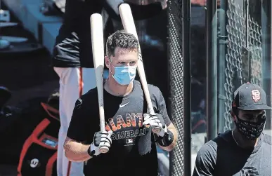  ?? JEFF CHIU THE ASSOCIATED PRESS FILE PHOTO ?? After opting out of the 2020 season to help care for his four children, six-time all-star Buster Posey, with the bats, returned in full to the San Francisco Giants for their first spring training workout for pitchers and catchers Wednesday.