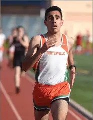  ??  ?? Portervill­e High School's Angel Roman wins the boys 1600-meter race Thursday.