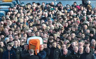  ??  ?? Tributes: Martin McGuinness’s coffin is taken through Derry’s Bogside yesterday