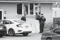  ?? Mike De Sisti / Associated Press ?? Officials investigat­e the scene of an early Sunday fatal shooting at Somers House Tavern in Kenosha County, Wis.