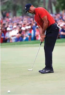  ??  ?? Tiger Woods watches his putt on the 18th which fell short of the hole and left him one shot adrift of winner Paul Casey