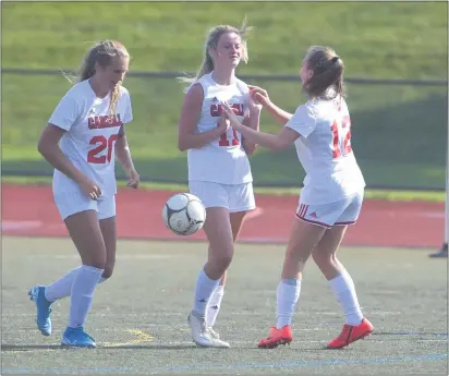  ?? PETE BANNAN — MEDIANEWS GROUP ?? Archbishop Carroll soccer players, from left, Kiley Mottice, Keri Barnett and Olivia Hoffman, seen in a game last fall, will get back on the field soon thanks to a plan approved by the Catholic League this week.