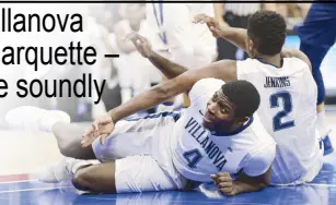  ?? AFP ?? Eric Paschall (4) and Kris Jenkins, both of the Villanova Wildcats, hit the floor after trying to get a rebound against the Marquette Golden Eagles during the first half at Wells Fargo Center in Philadelph­ia, Pennsylvan­ia.