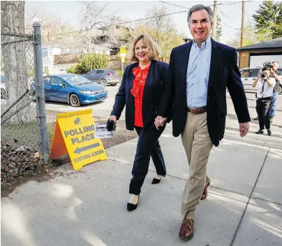  ?? JEFF MCINTOSH / THE CANADIAN PRESS ?? Alberta Conservati­ve Leader Jim Prentice and his wife, Karen, enter a polling station in Calgary on Tuesday.