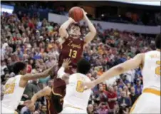  ?? TONY GUTIERREZ — THE ASSOCIATED PRESS ?? Loyola-Chicago’s Clayton Custer (13) shoots over Tennessee’s Jordan Bowden (23) and Jordan Bone (0) in the final seconds of a second-round game in Dallas, Saturday. The shot helped Loyola to a 63-62 win.