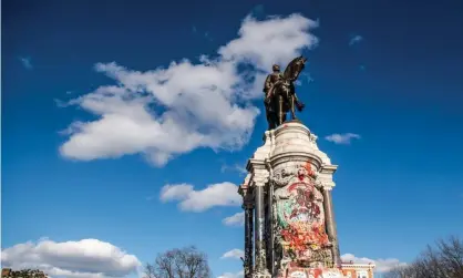  ?? Photograph: Chris Tuite/ImageSpace/Rex/Shuttersto­ck ?? The statue of Lee, pictured in January, atop a granite base that is covered in graffiti. Northam had announced plans to take down the statue in June last year.