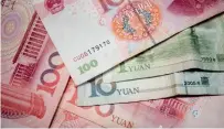  ?? — AFP ?? China has added a further 11 currencies in a trade-weighted foreign exchange basket to reduce the dollar’s dominance.