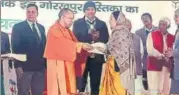  ?? HT PHOTO ?? CM Yogi Adityanath felicitati­ng a farmer whose land has been acquired for Gorakhpur link expressway.