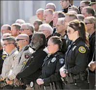  ?? Arkansas Democrat-Gazette/THOMAS METTHE ?? Law enforcemen­t officers from across Arkansas stand on the Capitol steps Wednesday as officials announce an opioids lawsuit that was filed in Crittenden County.