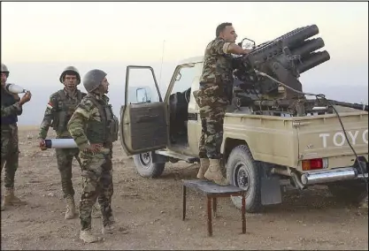  ?? AP ?? Kurdish troops prepare for an operation in a village near Mosul, Iraq.