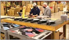  ?? (Special to the Democrat-Gazette/Nancy Raney and Bob Robinson) ?? Vince Signorelli (right) works with Justin Windstein as they construct a pickleball paddle at the Vulcan Sporting Goods manufactur­ing complex.