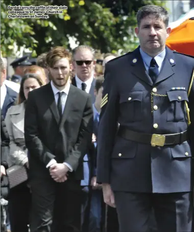  ??  ?? Gardaí carry the coffin of their slain colleague to St James’ Church in Charlestow­n on Sunday.