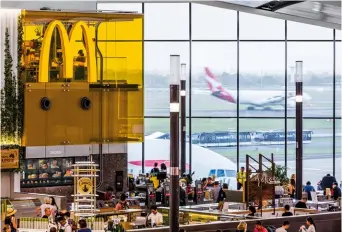  ??  ?? Above — Mcdonalds In The Sky is located next to a large panoramic window offering customers views of aeroplanes taking off and landing.