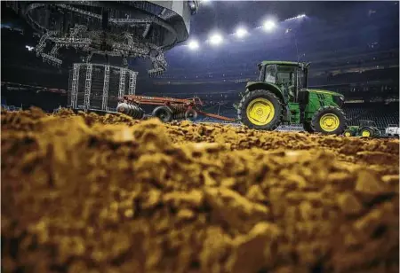  ?? Michael Ciaglo / Houston Chronicle ?? A tractor pulls a disc through the dirt at NRG Stadium in preparatio­n for the rodeo.