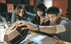  ??  ?? In “Wish Upon,” Joey King stars as Clare, who learns of a demon in the box with the help of Alice Lee and her cousin in the film, Ki Hong Lee.