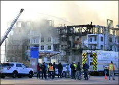  ?? . ANDY CROSS — THE DENVER POST T ?? Firefighte­rs work to contain a five-alarm fire at a multifamil­y residentia­l building under constructi­on on Peoria Street between Colfax and 14th Avenue in Aurora on Saturday.