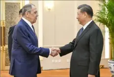  ?? Li Xueren/Xinhua via AP ?? Russian Foreign Minister Sergey Lavrov, left, and Chinese President Xi Jinping meet Tuesday at the Great Hall of the People in Beijing.