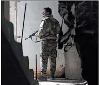  ?? AP/FELIPE DANA ?? Members of the U.S.-backed Syrian Democratic Forces walk through a building Saturday as they battle Islamic State militants in Baghouz, Syria.