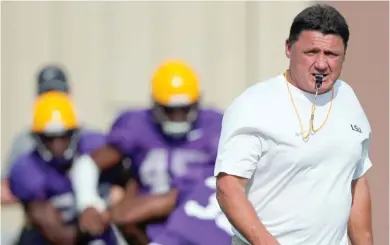  ?? (Photo by Gerald Herbert, AP) ?? LSU football head coach Ed Oregon walks across the field during practice in Baton Rouge, La. Orgeron grew up an LSU fan in Cajun country along the Bayou Lafourche in Larose, Louisiana, where his mother still lives. The Tigers' coach is about to begin...