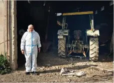  ?? ?? Giorgos Didangelos stands in front of his pig farm unit after the storm. The water rose to 3 meters in the facility, sweeping everything away.