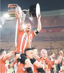  ?? — AFP photo ?? Athletic Bilbao’s Spanish forward Iker Muniain raises the trophy after winning the Spanish Copa del Rey (King’s Cup) final football match between Athletic Club Bilbao and RCD Mallorca.