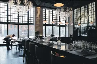  ??  ?? The multi- levelled dining room features high ceilings, floor- to- ceiling windows and beautiful chandelier­s.