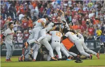  ??  ?? Oregon State players celebrate after beating Arkansas 5-0 in Game 3 to win the College World Series on Thursday in Omaha, Neb.