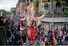  ?? AP ?? Devotees participat­e in a procession transporti­ng a giant idol of Ganesha to a worship venue in preparatio­n of Ganesha Chaturthi festival in Mumbai on Saturday. The ten-day festival will begin on August 25. —