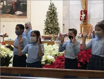  ?? PHOTOS COURTESY OF ST. MARY CATHOLIC SCHOOL ?? St. Mary Catholic School fifth-graders perform “Silent Night” with sign language.