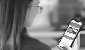  ??  ?? A mother of a student checks the study report of her child with an AI applicatio­n developed by New Oriental and its partners.