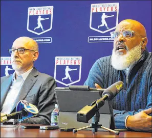  ?? Richard Drew The Associated Press ?? MLB Players Associatio­n executive director Tony Clark, right, and senior director Bruce Meyer led the negotiatio­ns for the players, who accepted the final deal despite a recommenda­tion against by the executive board.