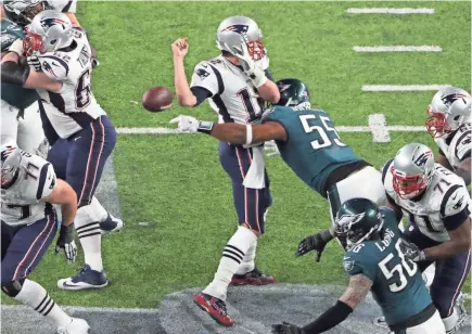  ?? KEVIN JAIRAJ/USA TODAY SPORTS ?? Patriots quarterbac­k Tom Brady fumbles the ball as he is hit by Eagles defensive end Brandon Graham during the pivotal fourth quarter.