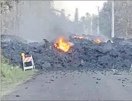  ?? Hawaii Electric Light ?? LAVA FLOWS over Mohala Street in Leilani Estates. Tourism officials said the eruption affected a limited area on Hawaii Island and posed no threat elsewhere.