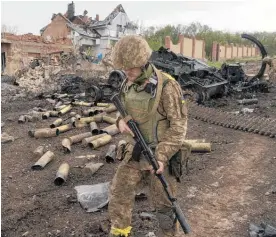  ?? Photo / AP ?? Ukrainian servicemen patrol in a recently retaken village, north of Kharkiv.