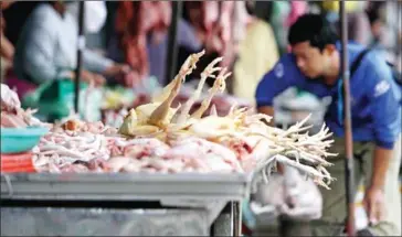  ?? HENG CHIVOAN ?? A vendor sells chickens at Kandal market in the capital’s Daun Penh district in 2022.