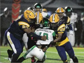  ?? DAVID JABLONSKI / STAFF ?? Springfiel­d’s Tywan January (left), Jokell Brown (back center) and Jaivian Norman (right) tackle Northmont’s Bryant Callahan on Friday.