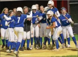  ?? SAM STEWART - DIGITAL FIRST MEDIA ?? The Exeter softball team gets ready to celebrate with Karysa Karas (7) after Karas’ three-run home run during a game against Owen J. Roberts on April 18.