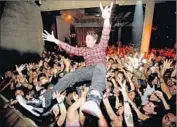  ?? Misha Vladimirsk­iy ?? AWAY FROM his turntable, Adam “DJ AM” Goldstein surfs the crowd in a scene from “As I AM.”