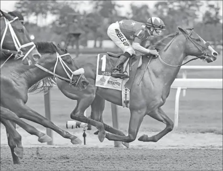  ?? Frank Franklin II Associated Press ?? THE NUMBER FITS Justify, ridden by Mike Smith, as he takes the early lead and never gives it up on the way to the Triple Crown.