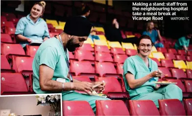  ?? WATFORD FC ?? Making a stand: staff from the neighbouri­ng hospital take a meal break at Vicarage Road