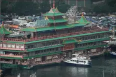  ?? Kin Cheung/Associated Press ?? Hong Kong's iconic Jumbo Floating Restaurant is towed away Tuesday after its parent company failed to find a new owner and lacked funds to maintain the establishm­ent amid months of COVID-19 restrictio­ns.