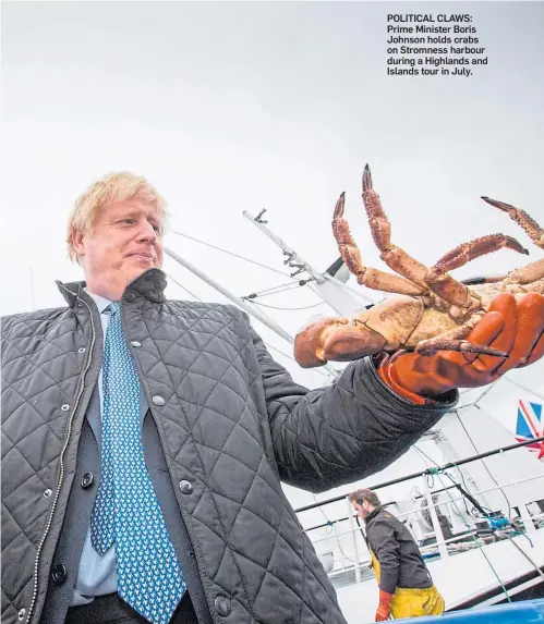  ??  ?? POLITICAL CLAWS: Prime Minister Boris Johnson holds crabs on Stromness harbour during a Highlands and Islands tour in July.