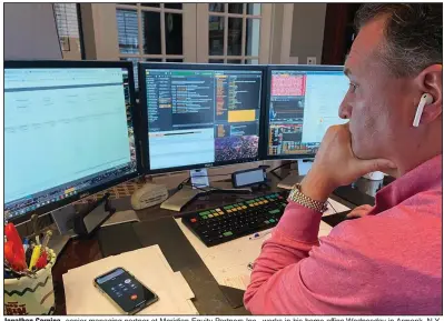  ?? (AP/Courtesy Jonathan Corpina) ?? Jonathan Corpina, senior managing partner at Meridian Equity Partners Inc., works in his home office Wednesday in Armonk, N.Y., while the New York Stock Exchange trading floor remains closed.