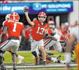  ?? John Bazemore
The Associated Press ?? Georgia quarterbac­k Stetson Bennett passes to wide receiver Marcus Rosemy-jacksaint in Saturday’s 23-17 SEC victory against Tennessee.