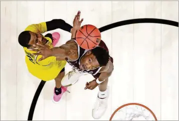  ?? ASSOCIATED PRESS] [PHOTOS BY ALEX GALLARDO/THE ?? Michigan guard Muhammad-Ali Abdur-Rahkman (left) shoots against Texas A&M forward Robert Williams during the second half of an NCAA Tournament regional semifinal Thursday in Los Angeles.