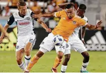  ?? Michael Wyke / Contributo­r ?? The Dynamo’s Darwin Ceren (24) is harassed by Fafa Picault during Philadelph­ia’s 3-1 win that broke the Dynamo’s 10-game unbeaten run at BBVA Compass Stadium.